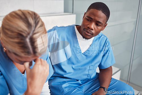 Image of Doctors, nurses or healthcare team with stress and depression talking about empathy. Black man support crying woman in hospital with mental health, depression and anxiety for crisis fail or mistake