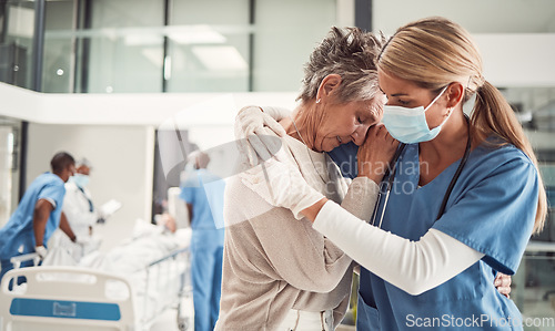 Image of Doctor, hug and sad senior woman in hospital for support, comfort and empathy for surgery of husband. Medic, face mask and embrace wife of patient with covid 19 emergency in clinic with solidarity