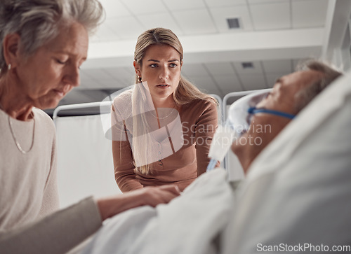 Image of Sick, senior and family with a man in hospital for medical support with sad and worried people. Healthcare, ill and woman and daughter with an elderly patient after an accident, injury or dying