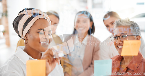 Image of Planning, strategy or happy black woman writing a marketing or advertising plan for business ideas. Sticky notes, meeting or creative people working on global startup project target or team goals