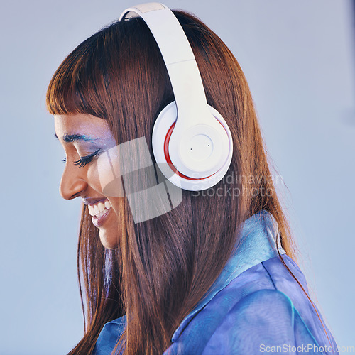 Image of Headphones, music and black woman isolated on purple background for cyberpunk fashion and creative gen z. Young person or beauty model listening on audio technology, pop art and cosmetics in studio