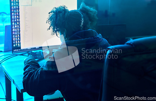 Image of Computer hacker, night and neon woman hacking database software, online server or programming password phishing. Ransomware developer, cyber security back view and blue programmer coding malware code