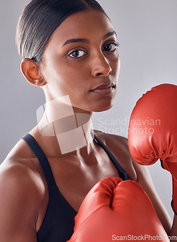 Image of Boxer, gloves and portrait of woman in studio for sports exercise, strong muscle or mma training. Indian female, boxing workout and fist fight for impact, energy and warrior power in battle challenge