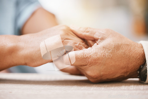 Image of Love, praying or old couple holding hands together in a Christian home in retirement with hope or faith. Jesus, religion or belief with a senior man and woman in prayer to god for spiritual bonding