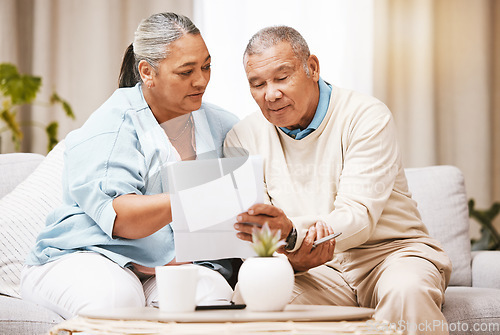 Image of Finance documents, sofa and senior couple with paperwork for taxes, mortgage payment and savings. Home insurance, banking and elderly man and woman with banking form for loan, investment and pension