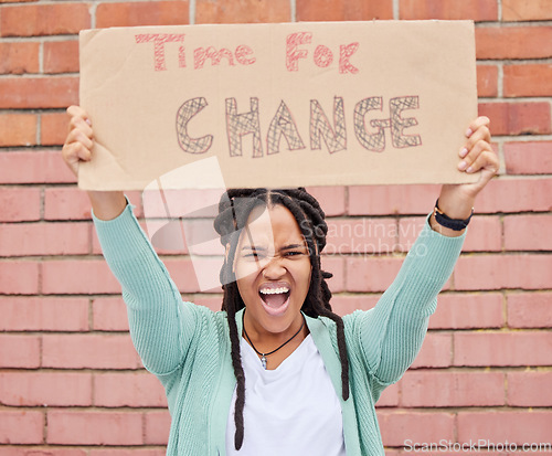 Image of Protest, change and portrait of black woman with voice for human rights, gender equality and racism on brick wall. USA youth, gen z person or student with cardboard sign, freedom of speech and angry