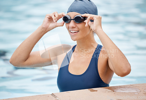 Image of Swimming pool, goggles and girl in water doing training for swimmer race and sports. Fitness, swim workout and stroke exercise of a student ready to start underwater sport practice with a smile