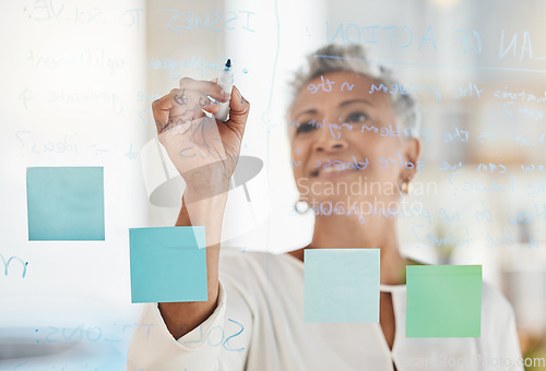 Image of Senior business woman, writing and planning schedule for corporate strategy, ideas or tasks at office. Elderly female CEO in project management, brainstorming or sticky note plan for company goals