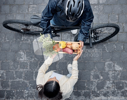 Image of Grocery delivery, courier and cycling man with retail sales product, shopping nutritionist or food shipping container. Logistics supply chain, customer top view and distribution person with bicycle