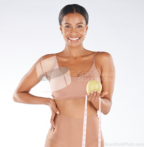 Image of Health diet, apple and happy woman with tape measure to track weight loss transformation, fitness model or body goals. Fruit detox, vegan healthcare food and portrait girl with nutritionist lifestyle