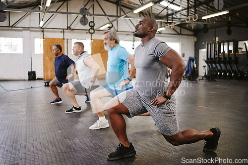 Image of People, fitness and stretching legs in class with personal trainer at gym for workout, exercise or training. Diverse group in warm up leg lunge session with coach for cardio wellness on floor