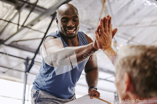 Image of Fitness, gym and man high five for senior support, personal trainer goals and exercise progress. Workout, success and elderly person with black man for achievement and hands together sign in training