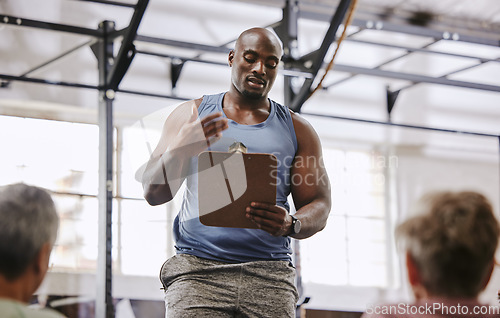 Image of Coaching, gym checklist and black man talking to senior clients at training introduction, welcome or membership. Personal trainer fitness, workout or exercise schedule, sign up and USA community club