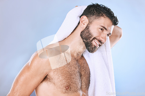 Image of Man after shower with hygiene, towel and beauty, smile and grooming with wellness in studio. Skincare, cosmetics and cleaning body with healthy skin, dermatology and cosmetic care on blue background
