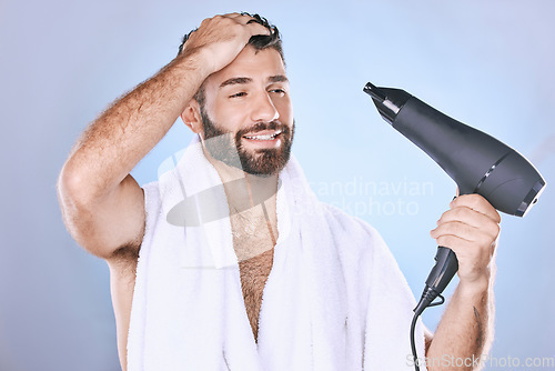 Image of Beauty, hair care and man with blow dryer on blue background for cleaning, body wellness and salon. Luxury spa, shower and male with drying appliance for grooming, shine and cosmetics treatment