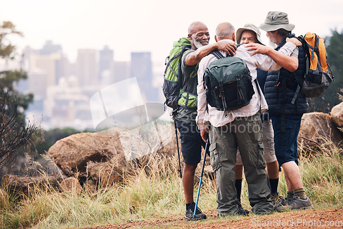 Image of Hiking, city and hug with old men on mountain for fitness, trekking and backpacking adventure with mockup. Support, motivation and expedition with friends on trail for health, retirement and journey