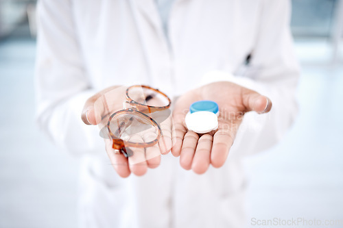 Image of Eye care, choice with glasses or contact lens in hands, closeup and vision with healthcare for eyes. Prescription lenses, person with frame and plastic container, optometry with optician and health