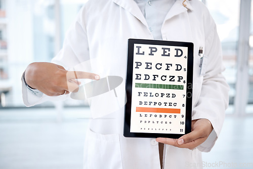 Image of Hands, tablet screen and eye chart in hospital for vision examination in clinic. Healthcare, snellen or woman, ophthalmologist or medical doctor pointing to technology showing letters for eyes test.