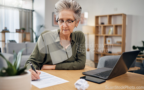 Image of Focus, writing and senior woman for asset management, planning and paperwork of financial investment. Insurance, budget ideas or taxes on laptop of boss, executive or entrepreneur in home living room