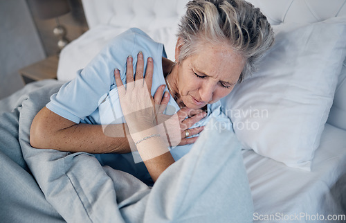 Image of Heart attack, senior woman and chest pain, anxiety or medical emergency in her bedroom. Heartburn, stress or stoke of elderly person cardiology, breathing and lung problem with healthcare risk