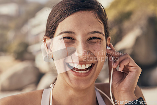 Image of Music, fitness and portrait of woman at the beach for running, training and cardio. Happy laugh, face and radio for girl in nature for exercise, wellness and motivation with funny podcast