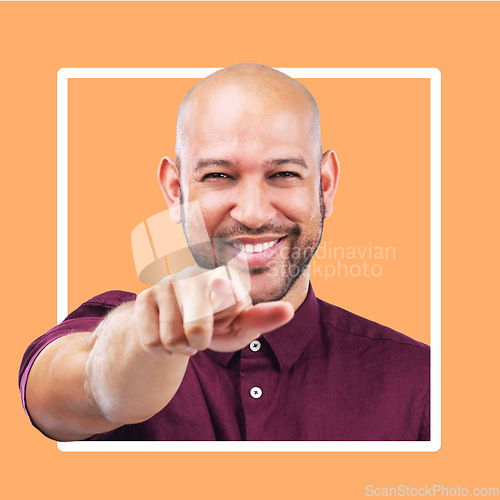 Image of Portrait, pointing and frame with a black man in studio on an orange background to choose an option. Face, point and border with a handsome male using his finger to make a selection or choice