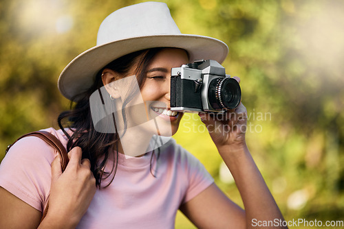 Image of Photography, smile and woman with a camera in nature during travel in Singapore. Vacation, tourism and professional ecology photographer in a botanical garden to capture the natural environment