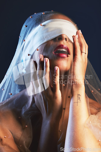 Image of Blindfolded, veil and woman in studio for creative, fashion and artistic aesthetic on black background. Model, blind and covered vintage beauty by girl model with luxury, fabric and elegant clothing