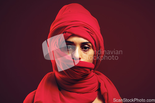Image of Hijab, muslim and portrait of a islamic woman in studio with dark background. Serious, covered and red arab head dress with a young person with religious, culture and islam fashion scarf with mockup