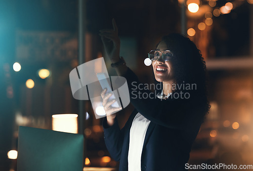 Image of Business woman, phone and night in the office with bokeh lights to work late for project deadline. African American female employee working overtime with smartphone technology in a dark workplace