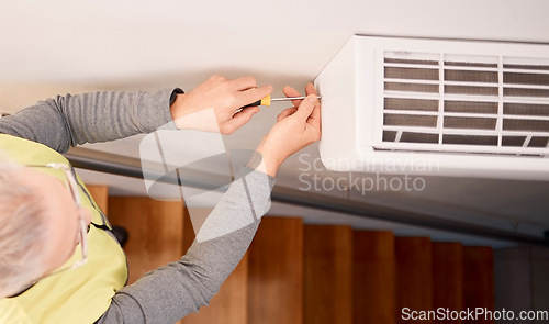 Image of Service, installation and above of a man with an air conditioner, maintenance and ac repair. Building, contractor and a handyman fitting a tool on a wall of a home for home improvement and heat