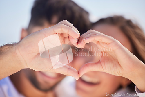 Image of Heart shape, happy and couple on a date for valentines day, romance or anniversary vacation. Happiness, holiday and young man and woman with a love hand sign or gesture while on a weekend trip.