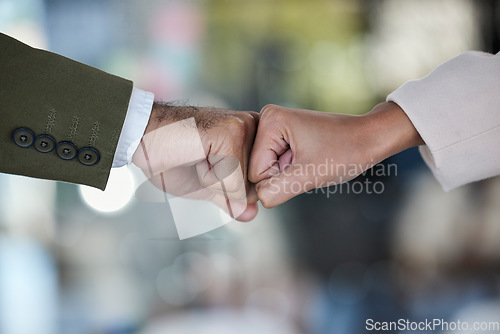Image of Hands, fist bump and trust in corporate partnership for unity, agreement or deal against blurred background. Hand of people bumping fists in collaboration for teamwork, goals or support for winning