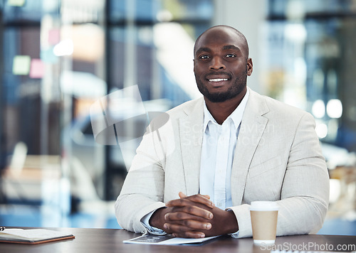 Image of Success, corporate and portrait of a black man in an office for a meeting, planning and seminar. Trust, smile and African businessman sitting at a table ready for a conference, workshop or interview