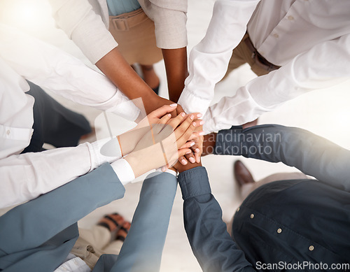 Image of Team, diversity and stack of hands in the office for unity, celebration or support for solidarity. Collaboration, multiracial and top view of group of business people with motivation and in workplace