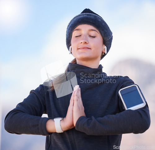 Image of Woman, praying hands and training at park, city or focus on meditation, breathing and start morning exercise. Gen z runner girl, smartphone and outdoor with peace for mindfulness, health and wellness