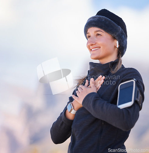 Image of Hands on chest, health and fitness with woman outdoor, peace and zen with fresh air, run and phone, earpods for music. Calm, nature view and 5g, happy runner or hiking, smartwatch and mockup space