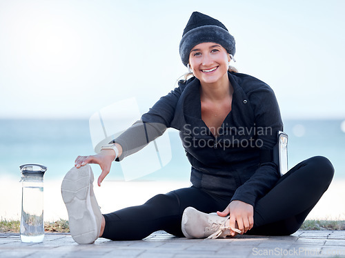 Image of Fitness, woman and stretching legs by beach in preparation for exercise, cardio workout or training. Portrait of happy female in warm up leg stretch ready for fun exercising by the ocean on mockup