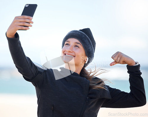 Image of Fitness, woman and beach with smile for selfie, profile picture or social media post in muscle flex. Happy sporty female vlogger or influencer smiling for photo memory, exercise or workout outdoors