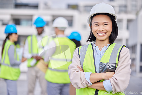 Image of Portrait, Asian woman arms crossed and engineer outdoor, building and inspector with smile, new project and deadline. Face, female employee and manager with hard hat, vest and construction inspector