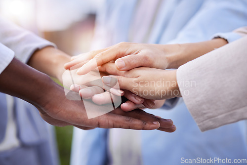 Image of Team, doctors and stack hands for motivation, support and collaboration with trust, solidarity and diversity. Close up, hand together and doctor with teamwork, goals and help in healthcare at clinic