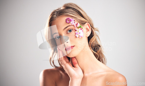 Image of Beauty, art and portrait of woman with flowers for natural cosmetics, skincare wellness and makeup product. Spring, studio and girl with petal on face for spa aesthetic, luxury facial and cosmetology