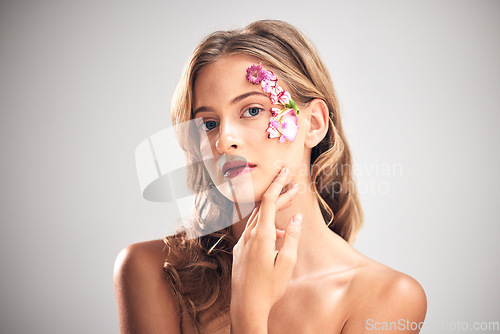 Image of Flower art, beauty and portrait of woman for natural cosmetics, skincare wellness and makeup in studio. Spring, creative and girl with petal on face for spa aesthetic, luxury facial and cosmetology