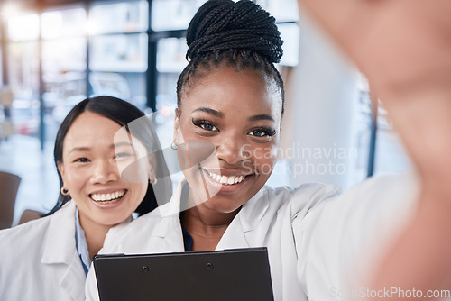 Image of Doctor, team selfie and women friends with smile, checklist and happy at clinic for profile picture. Medic, asian and black woman with team building, support and solidarity in hospital for portrait