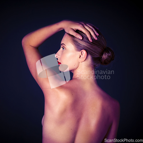 Image of Beauty, sensual and back of woman in a studio with a cosmetic, makeup of self care routine. Beautiful, seductive and profile of a young female model with a sexy pose isolated by a black background.