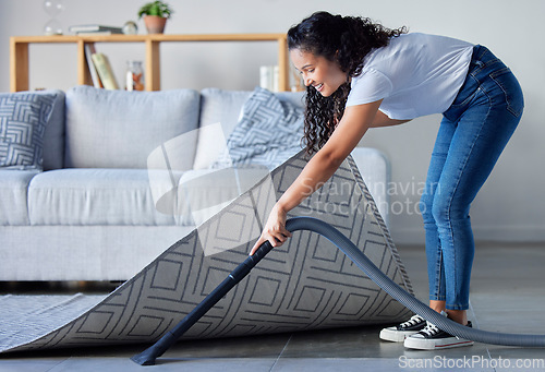 Image of Woman, vacuum and cleaning carpet floor in housekeeping for clean sanitary hygiene at home. Happy female cleaner in germ or dust removal in living room interior by sofa for daily chores or routine