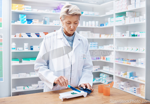 Image of Pharmacy woman, pills and counting in store for stock, product and medicine for health on table with tools. Pharmacist sorting, management and focus for retail pharma for healthcare service in shop