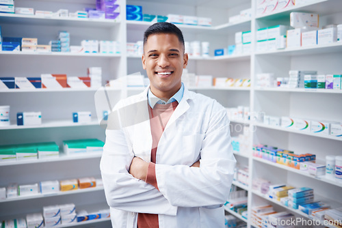 Image of Portrait, man and pharmacist with arms crossed in pharmacy or drugstore. Healthcare, wellness and happy, proud and confident smile of male medical professional, expert or doctor from Canada in shop.