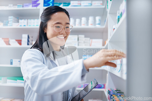 Image of Asian woman, tablet and pharmacist check stock in pharmacy for healthcare medicine in drugstore. Medication, technology and happy female medical doctor with touchscreen for checking inventory in shop