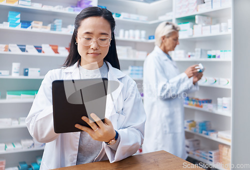 Image of Asian woman, tablet and pharmacist in pharmacy for healthcare or online consultation in drugstore. Medication, telehealth technology and female medical doctor with touchscreen for research in shop.